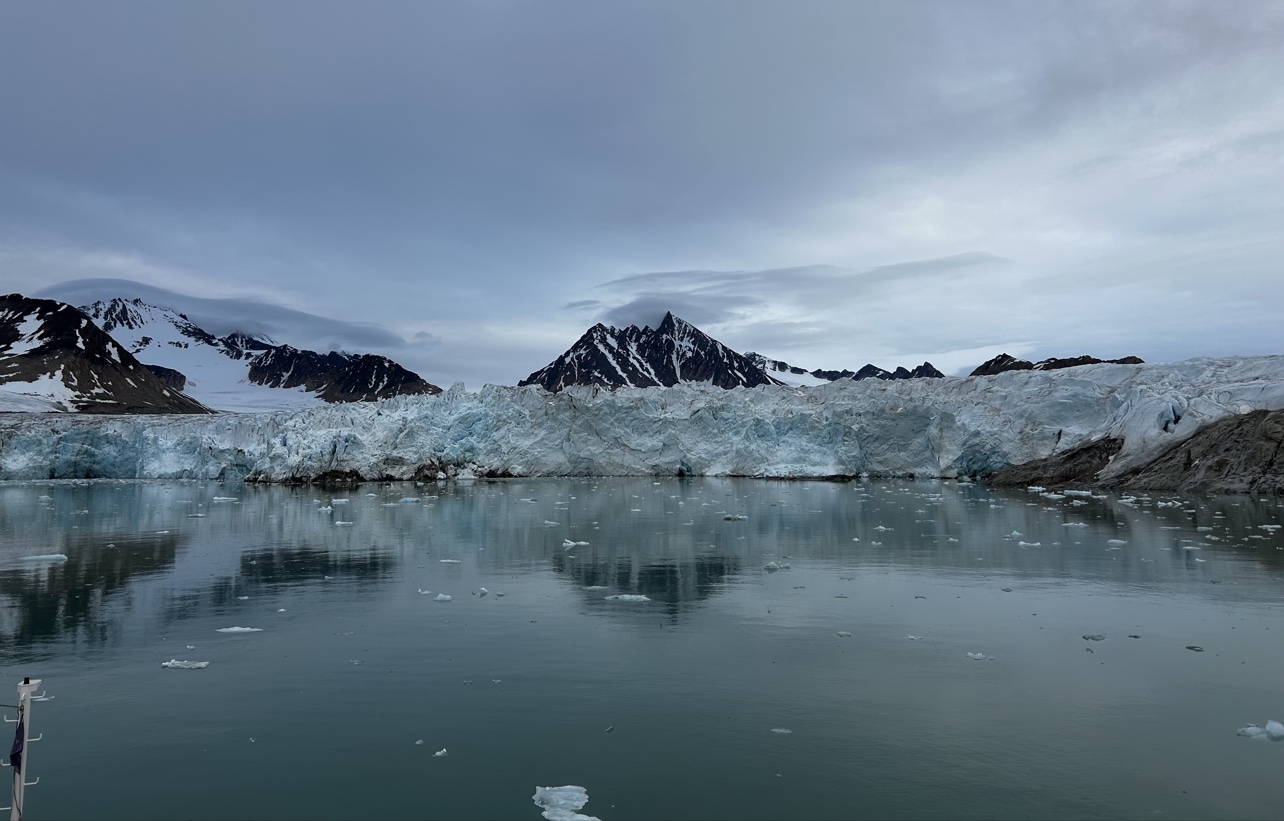 Glacier front and mountains across still water